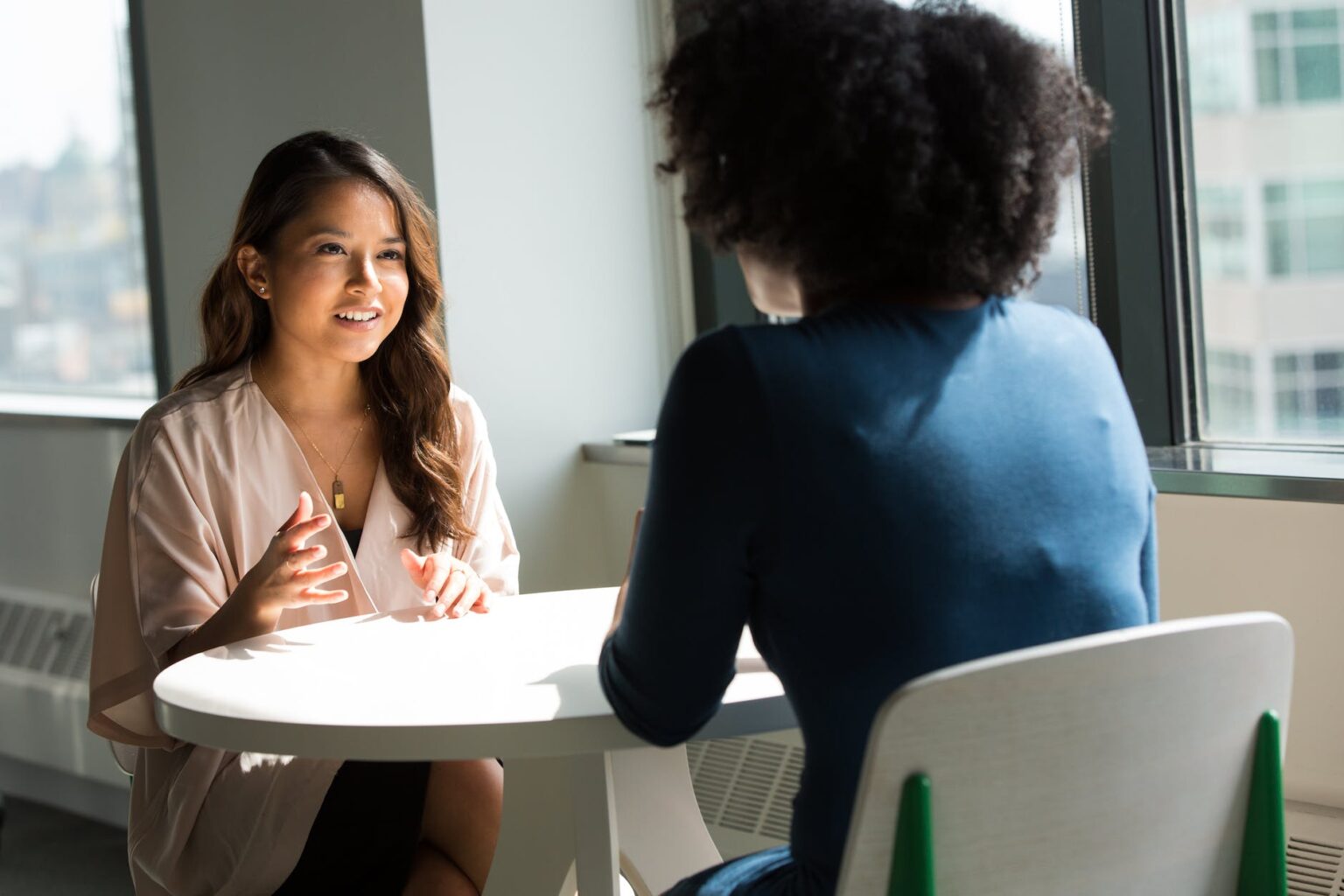 Top 5 Business Ideas to Help Insurance Companies Maintain Strong Customer Relations man wearing white top in front of woman wearing blue long sleeved top